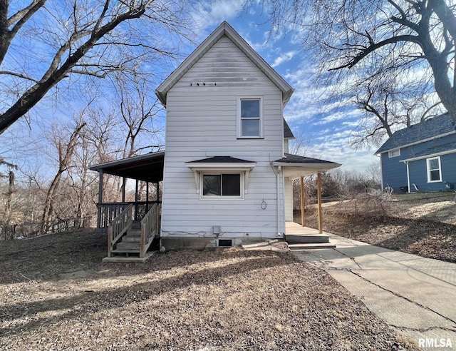 back of property featuring driveway