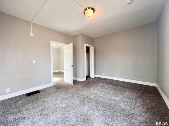 unfurnished bedroom featuring carpet floors, visible vents, and baseboards