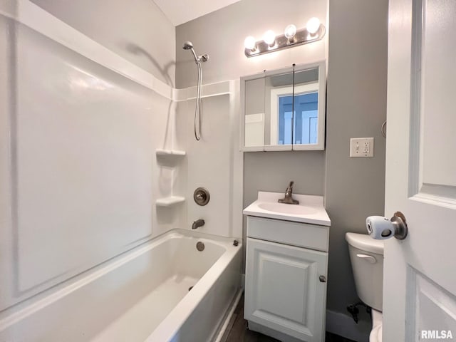 bathroom with bathing tub / shower combination, toilet, and vanity