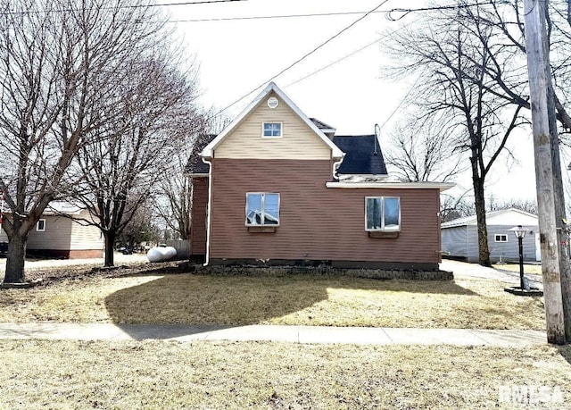 view of side of home with a lawn