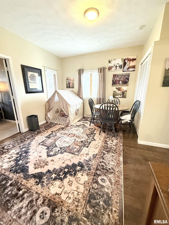 bedroom featuring a closet, baseboards, and wood finished floors