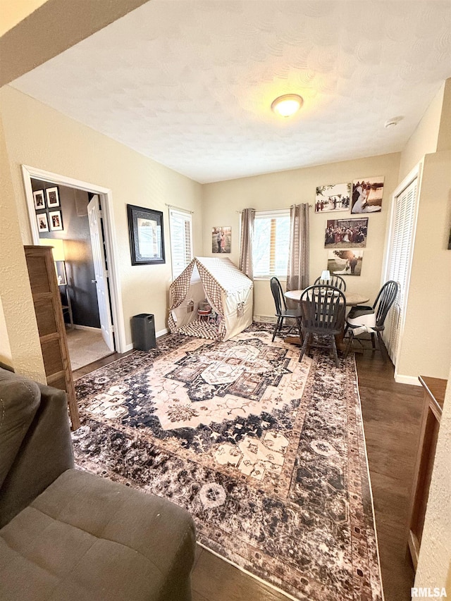 bedroom featuring a closet, baseboards, and wood finished floors