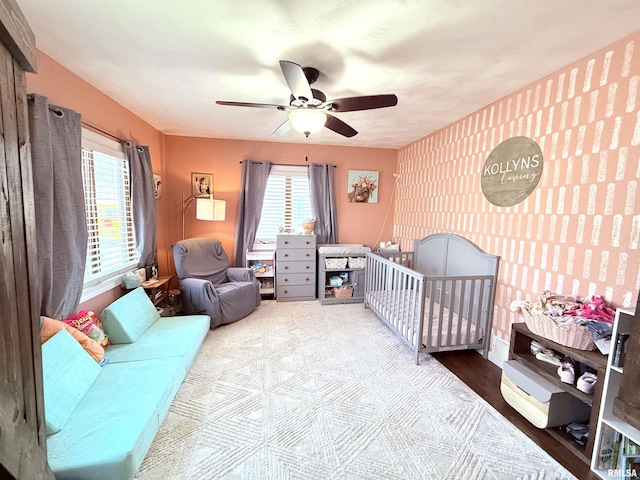 bedroom with an accent wall and a ceiling fan