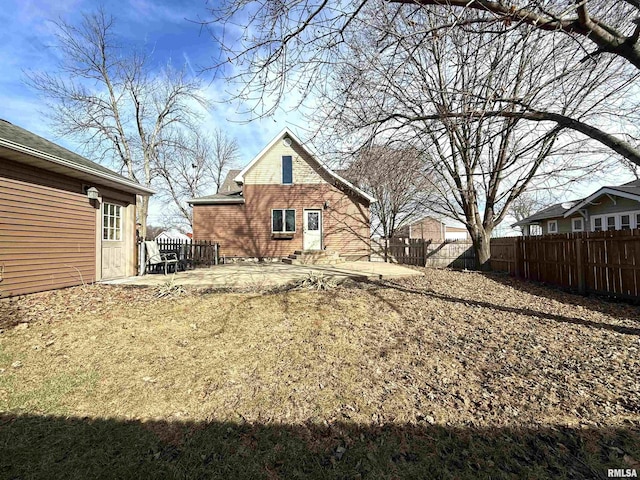 rear view of house with a patio area, entry steps, and fence