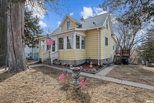 bungalow featuring entry steps and a shingled roof