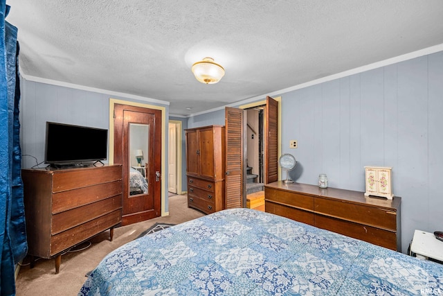 bedroom featuring carpet floors, a textured ceiling, and crown molding