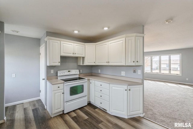 kitchen with electric range, baseboards, white cabinets, dark wood-type flooring, and light countertops