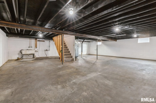 basement with stairs and a sink