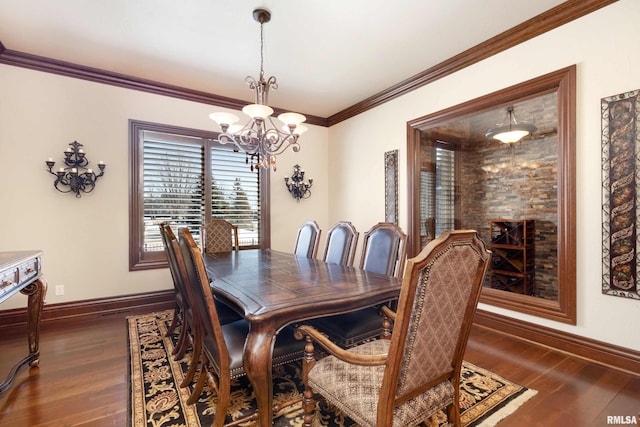 dining space featuring dark wood-style floors, crown molding, baseboards, and an inviting chandelier