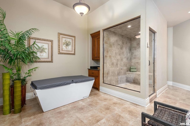 full bath featuring a stall shower and baseboards