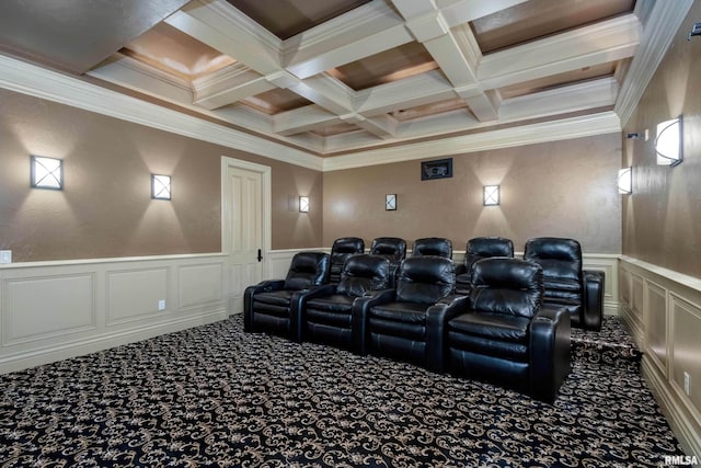 carpeted cinema with coffered ceiling, a wainscoted wall, crown molding, a decorative wall, and beam ceiling