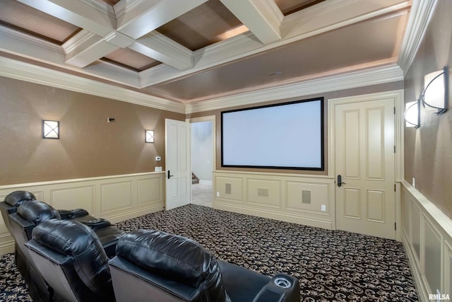 carpeted home theater with beam ceiling, a decorative wall, ornamental molding, wainscoting, and coffered ceiling