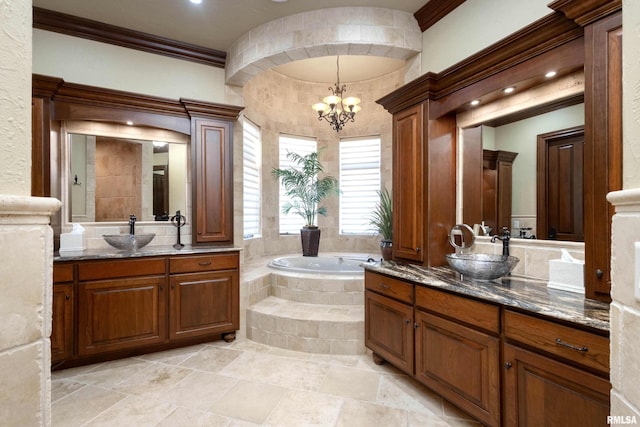 bathroom with a garden tub, ornamental molding, a sink, and an inviting chandelier