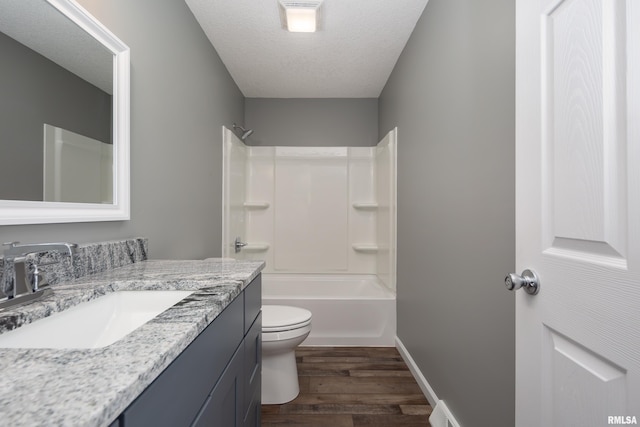 full bath with visible vents, toilet, wood finished floors, a textured ceiling, and vanity