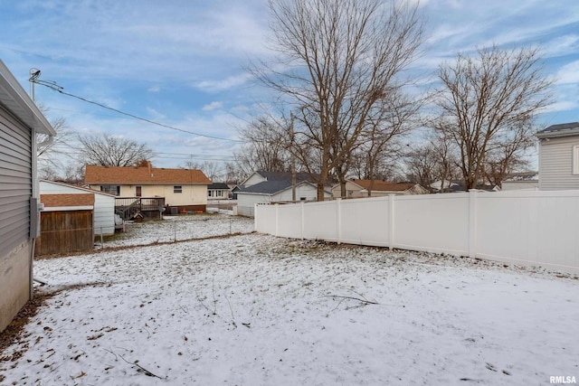 yard layered in snow with fence