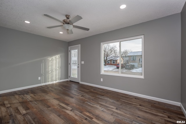 interior space featuring a textured ceiling, recessed lighting, dark wood-style flooring, a ceiling fan, and baseboards