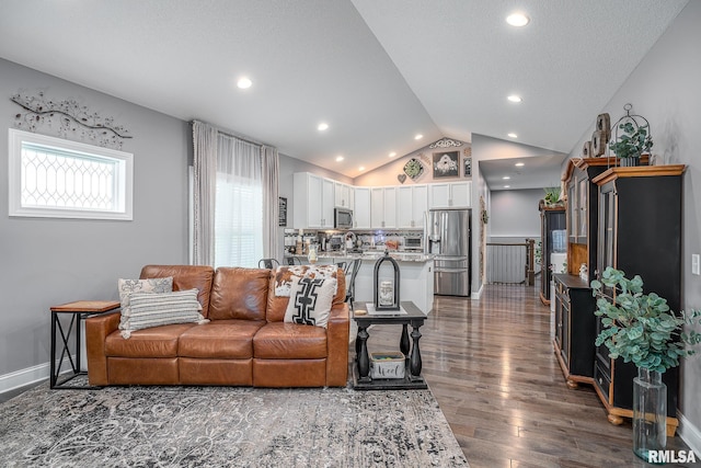 living area with baseboards, lofted ceiling, dark wood-style flooring, a textured ceiling, and recessed lighting