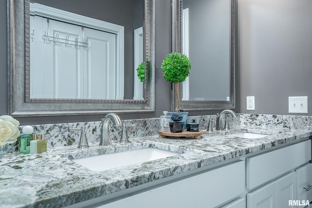 full bathroom featuring double vanity and a sink