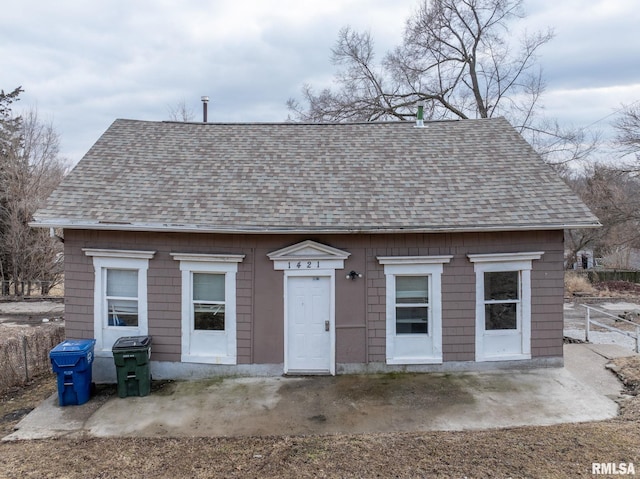 view of front of property featuring roof with shingles