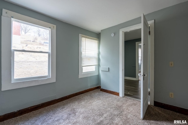 unfurnished bedroom with carpet floors and baseboards