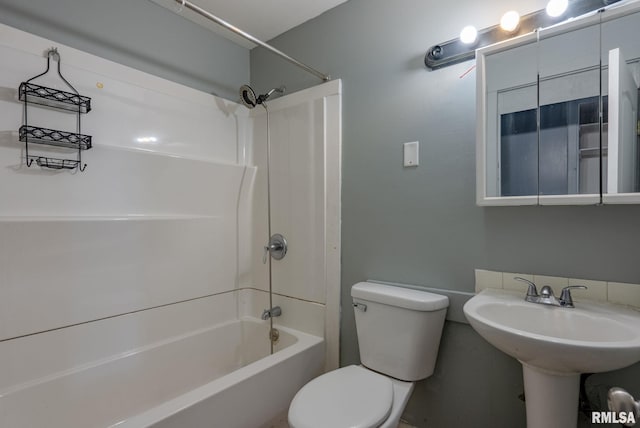 bathroom with tub / shower combination and toilet