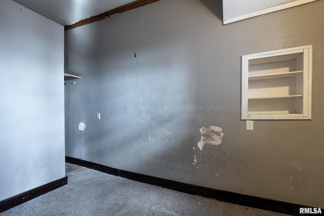 empty room featuring built in features and baseboards