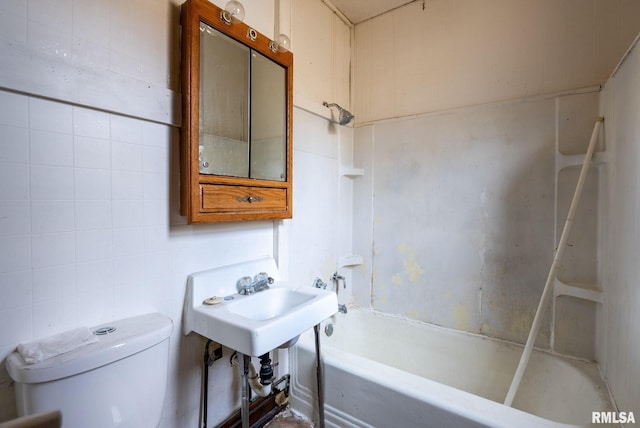 full bath with toilet, a sink, bathtub / shower combination, and tile walls