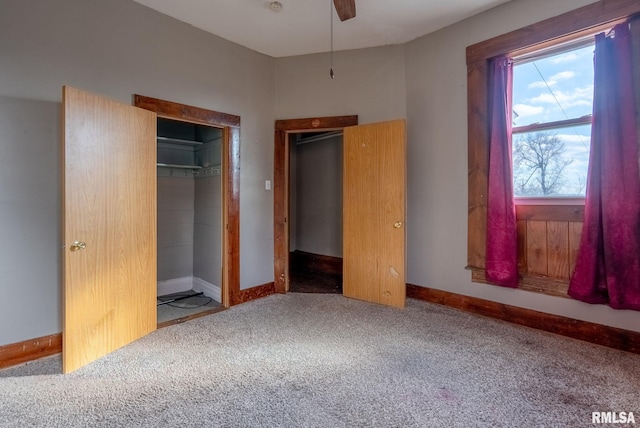 unfurnished bedroom featuring carpet, a closet, and baseboards