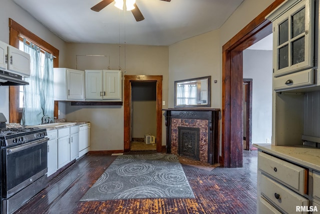 kitchen with light countertops, white dishwasher, gas range, and under cabinet range hood