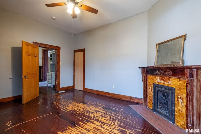 unfurnished living room with a fireplace with flush hearth, baseboards, ceiling fan, and hardwood / wood-style floors