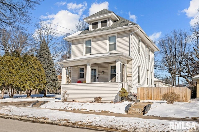 traditional style home with covered porch and fence