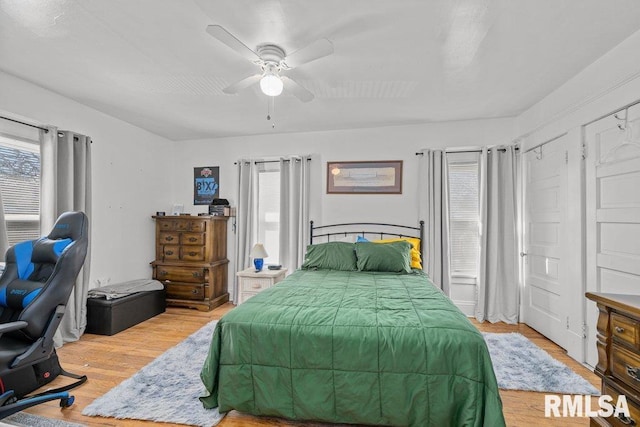 bedroom with a ceiling fan and light wood-style floors