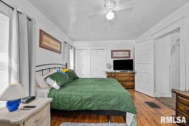 bedroom with visible vents, ceiling fan, and wood finished floors