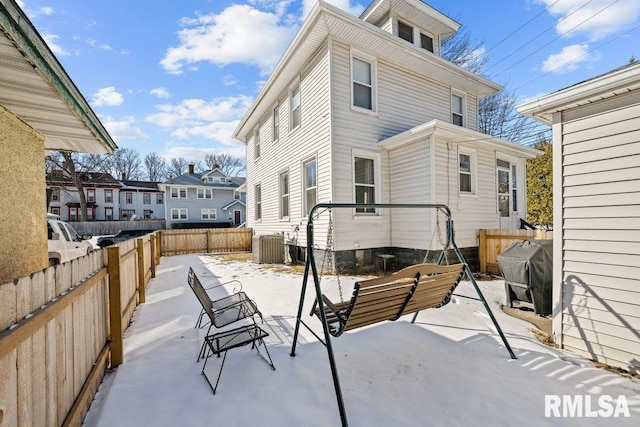 back of house featuring a patio, a fenced backyard, and central air condition unit