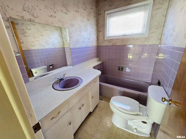 full bathroom with toilet, wallpapered walls, and wainscoting