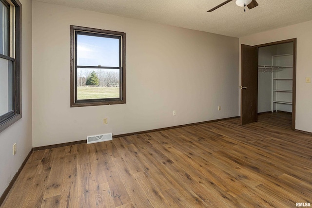1595 Casper Church Rd, Cobden, IL 62920 - unfurnished bedroom featuring visible vents, a textured ceiling, and hardwood / wood-style flooring