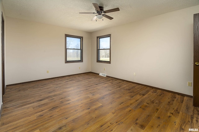 1595 Casper Church Rd, Cobden, IL 62920 - empty room with visible vents, baseboards, a textured ceiling, a ceiling fan, and wood-type flooring