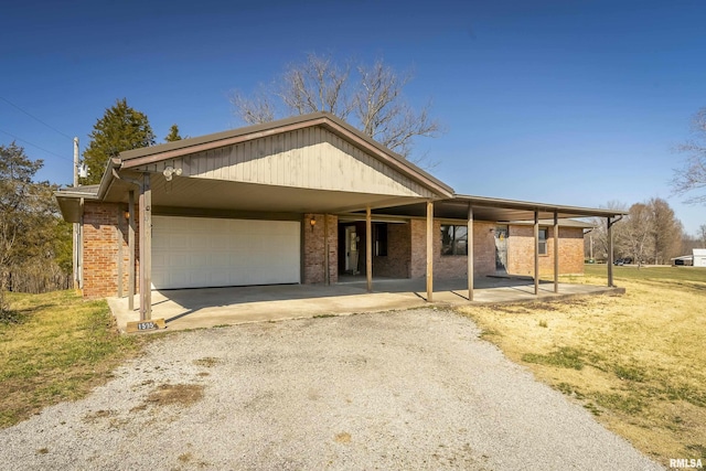 1595 Casper Church Rd, Cobden, IL 62920 - ranch-style home with brick siding, driveway, an attached garage, and a carport