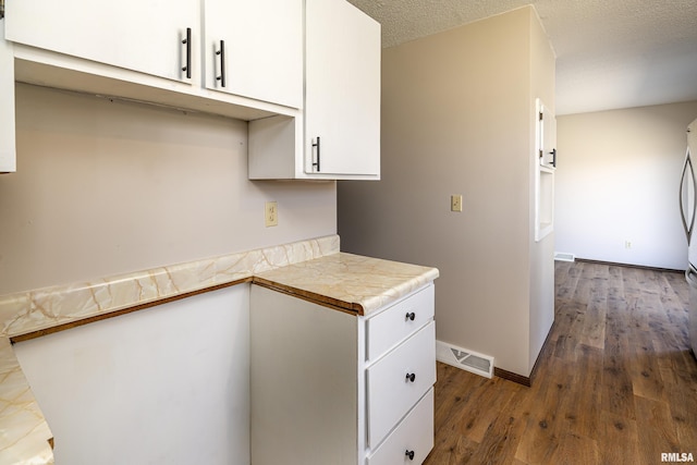 1595 Casper Church Rd, Cobden, IL 62920 - kitchen with visible vents, dark wood-type flooring, a textured ceiling, white cabinetry, and light countertops