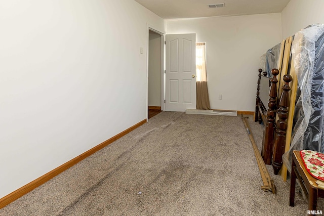 carpeted bedroom with visible vents and baseboards