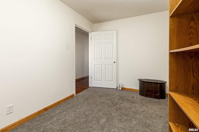 interior space featuring carpet and baseboards