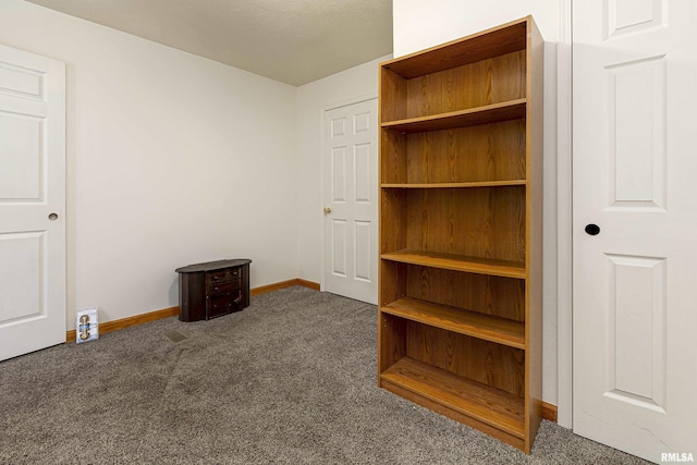 unfurnished bedroom featuring carpet flooring and baseboards