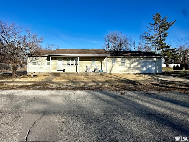 ranch-style house with a garage and driveway