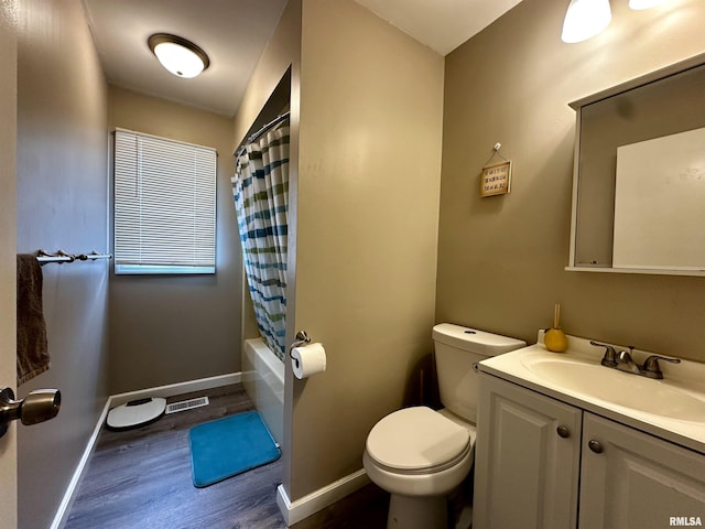 full bath with toilet, baseboards, wood finished floors, and vanity