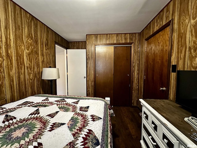 bedroom featuring a closet, dark wood finished floors, and wooden walls