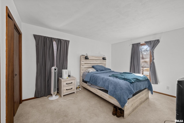 carpeted bedroom with baseboards