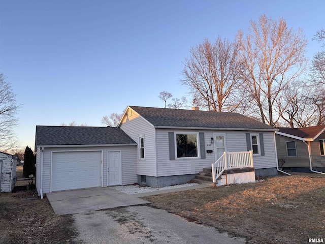 view of front facade featuring a garage, roof with shingles, driveway, and a chimney