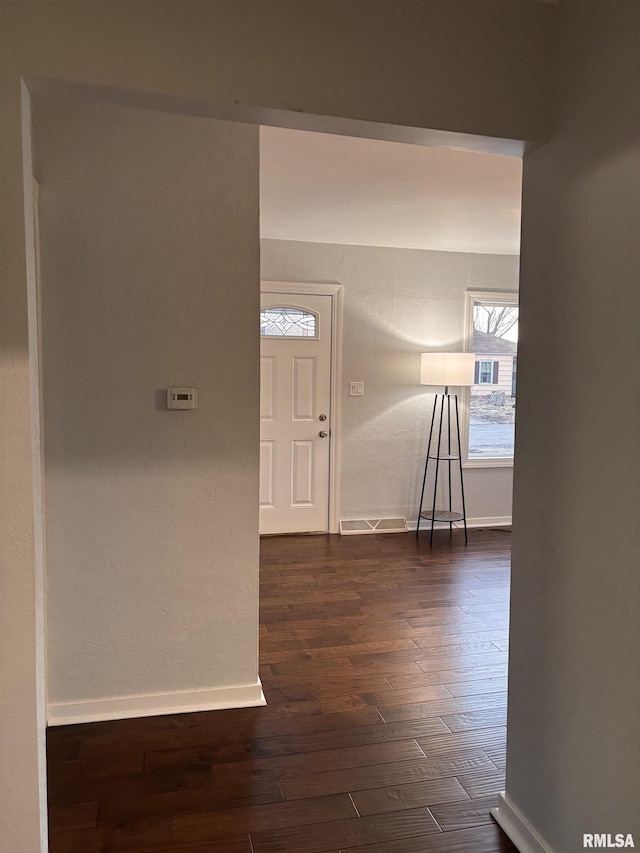 interior space with dark wood-style floors and baseboards