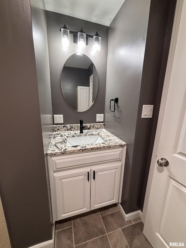 bathroom with baseboards and vanity