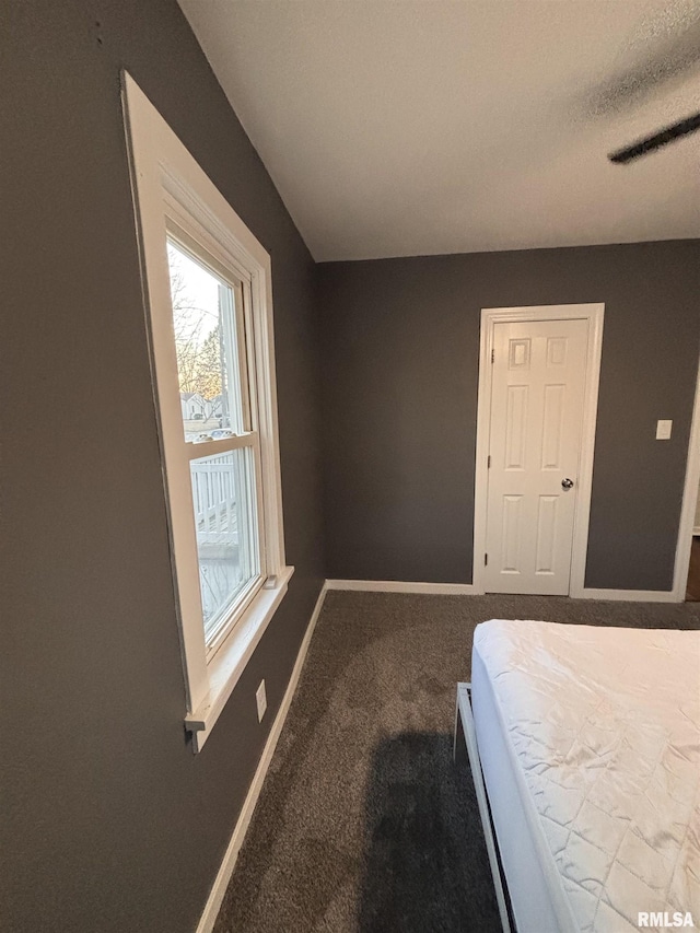 unfurnished bedroom with carpet, visible vents, and baseboards